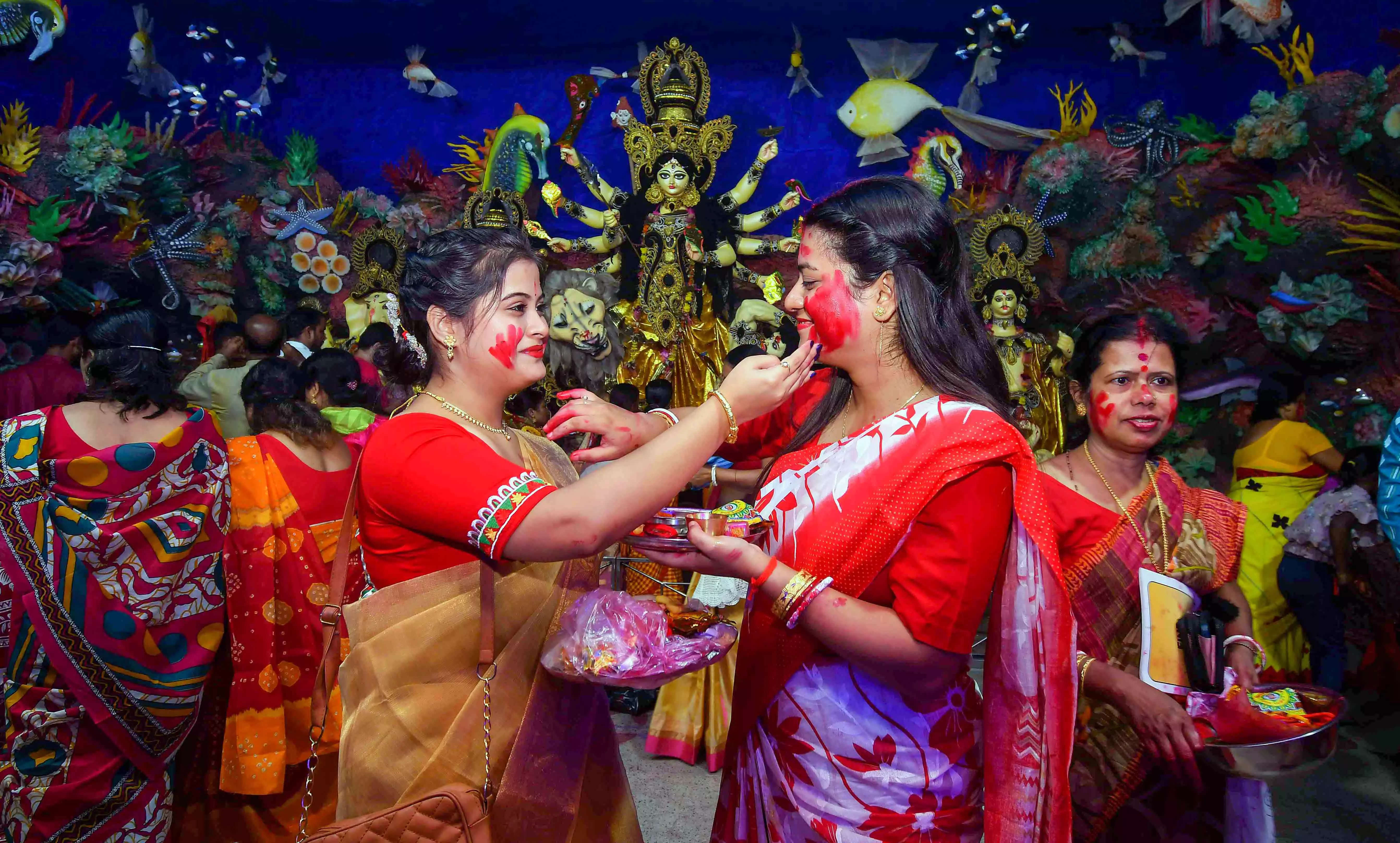 Women apply sindur (vermilion) on each other during the Sindoor Khela, Women apply sindur (vermilion) on each other during the Sindoor Khela,