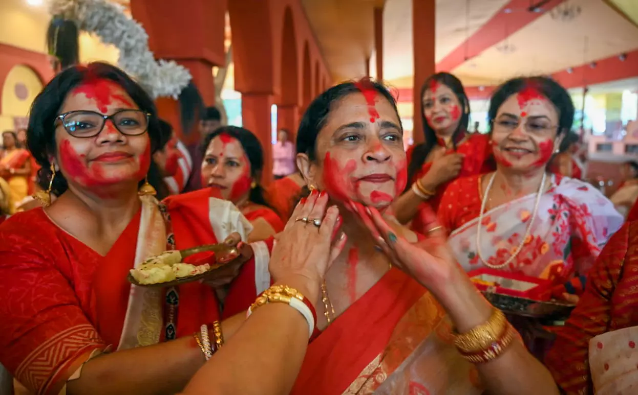 Women apply sindur (vermilion) on each other during the Sindoor Khela, Women apply sindur (vermilion) on each other during the Sindoor Khela,