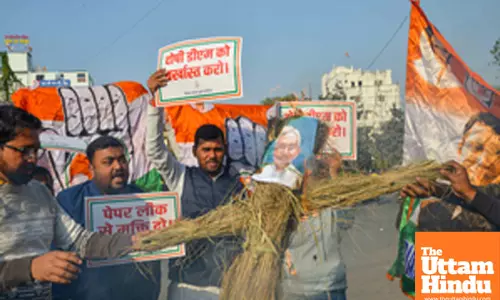 Patna: Youth Congress activists burn an effigy of Bihar Chief Minister Nitish Kumar to protest against the alleged paper leak