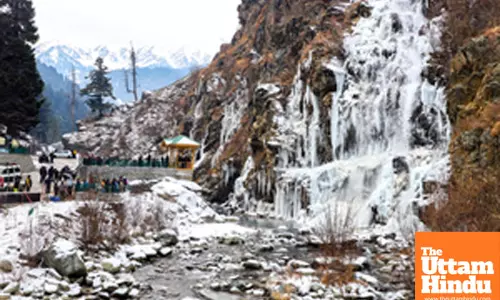 Baramulla: Tourists visit the frozen waterfall in the Drung area of Tangmarg