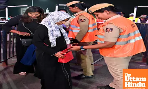 Bengaluru: Police personnel conduct bag checks on people during New Year celebrations at Brigade Road