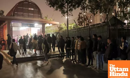 New Delhi: People stand in a queue outside Udyog Bhawan Metro Station
