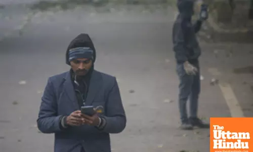 New Delhi: People walk along a foggy street as cold weather and reduced visibility