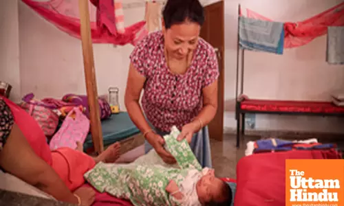 Bishnupur: A new mother cares for her baby at a relief camp
