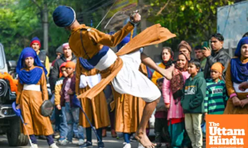 Noida: A Sikh devotee displays Gatka martial art skills during the Nagar Kirtan procession