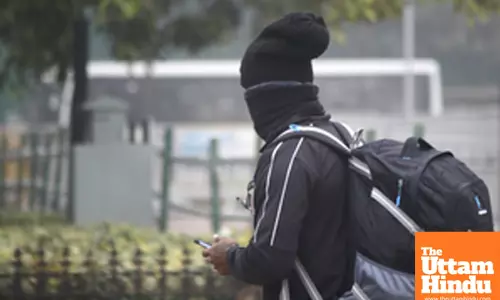 New Delhi: A man, dressed in woollen clothes, walks on a road amidst thick fog on a cold winter morning
