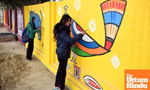 Prayagraj: Artists paint a wall with intricate and vibrant scriptures as the part of preprations
