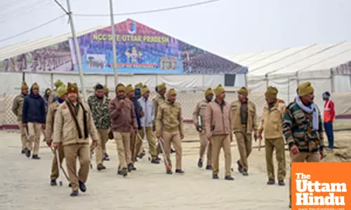 Prayagraj: Police personnel inspects the area near Sangam where preparations are underway
