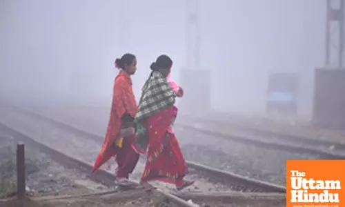 Nagaon: Women cross railway tracks amid dense fog on a cold winter morning
