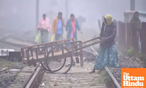 Nagaon: A man with his cart tries to cross railway tracks amid dense fog on a cold winter morning