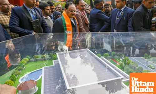New Delhi: BJP National President and Union Minister J.P. Nadda examines a model Sheesh Mahal