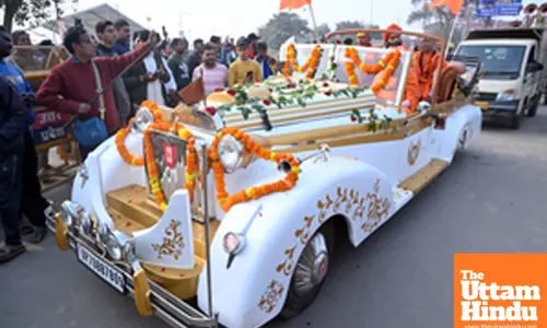 Prayagraj: Sadhus (holy men) arrive in a vintage car ahead of the Maha Kumbh Mela 2025 at Sangam
