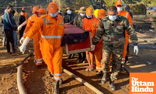 Dima Hasao: NDRF personnel carry the body after rescue teams recovered the second miner from the flooded coal mine