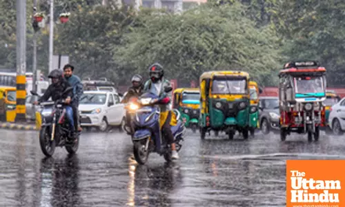 Jaipur: Vehicles pass through the streets amid rainfall