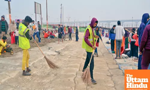 Prayagraj: Workers sweep the ground on a cold morning as part of preparations