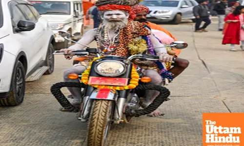 Prayagraj: Sadhus (Holy Men) arrive on a bike at the banks of the Sangam