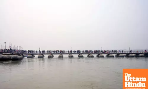 Prayagraj: Devotees walk over the pontoon bridges over the Sangam
