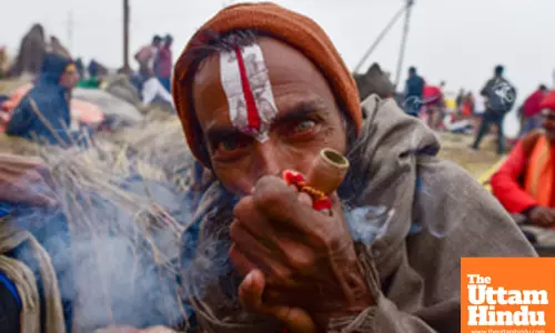 Prayagraj: A Sadhu (Holy Man) smokes a chillum, a traditional clay pipe,