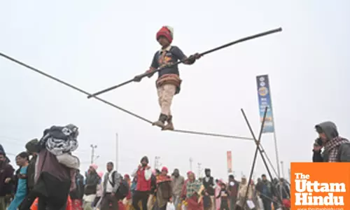 Prayagraj: A young girl performs a tightrope act at the banks of Sangam,