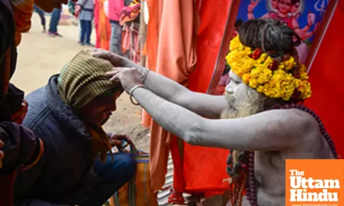 Prayagraj: Devotees seek blessings from a Sadhu (holy man) at the Triveni Sangam
