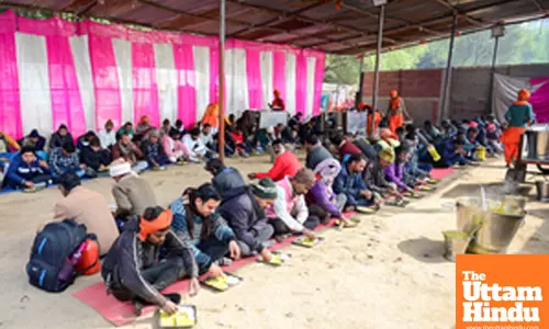 Prayagraj: Devotees eat prasadh at a pandal near Sangam during the Maha Kumbh Mela 2025