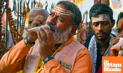 Prayagraj: A man blows a shankh (conch shell) at the Triveni Sangam