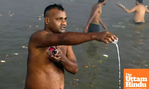 Prayagraj: A devotee takes a holy dip and offers prayers at the Triveni Sangam
