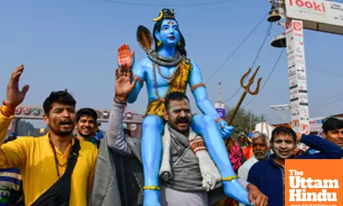 Prayagraj: Devotees carry a statue of Lord Shiva at the Triveni Sangam during the Maha Kumbh Mela 2025