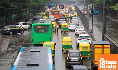 Bengaluru: Vehicles navigate through a wet road following untimely rain