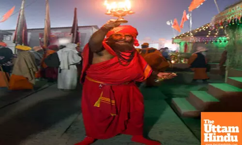 Prayagraj: A sadhu performs aarti at a camp during the Maha Kumbh Mela