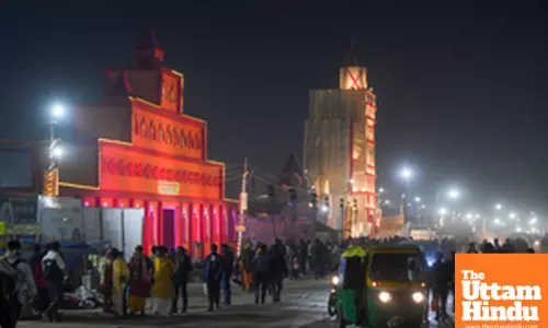 Prayagraj: People stroll near the illuminated entrance at the Maha Kumbh Mela site