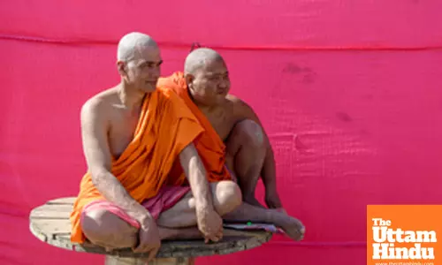 Prayagraj: Monks dressed in saffron robes sit together at a camp during the Maha Kumbh Mela