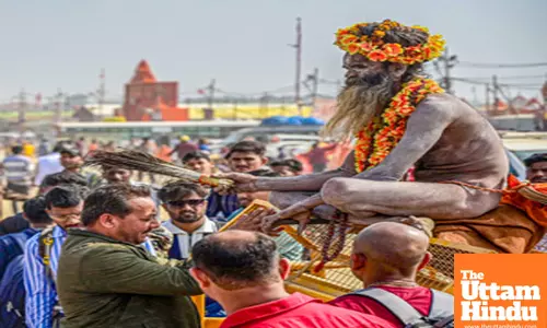 Prayagraj: A devotee seeks blessings from a sadhu at the Sangam during the Maha Kumbh Mela 2025