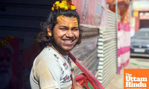 Prayagraj: A devotee poses for a photo at the Triveni Sangam