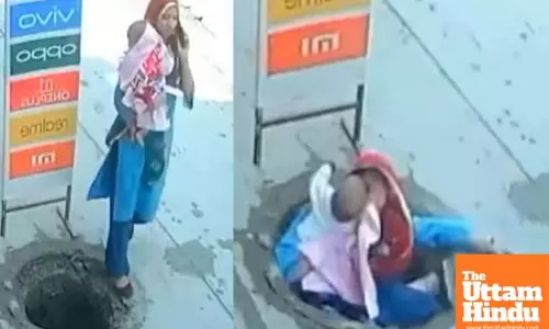 WATCH: Woman Holding Baby Falls Into Open Manhole While on Phone, CCTV Footage Raises Alarms
