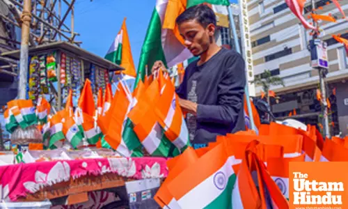 Nagpur: A roadside vendor arranges Indian national flags ahead of Republic Day celebrations