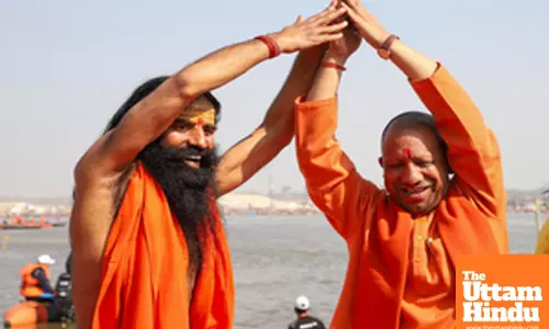 Prayagraj: Uttar Pradesh Chief Minister Yogi Adityanath and yoga guru Ramdev perform yoga poses