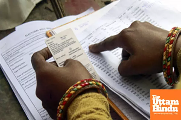 A polling official checks the identity card of a voter