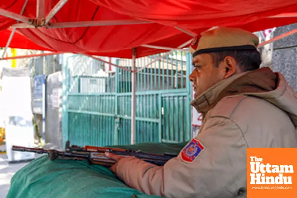 Delhi Police personnel conduct security preparations at the Gole Market counting center