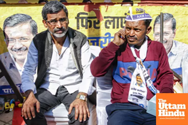 AAP supporters wait outside the Aam Aadmi Party office