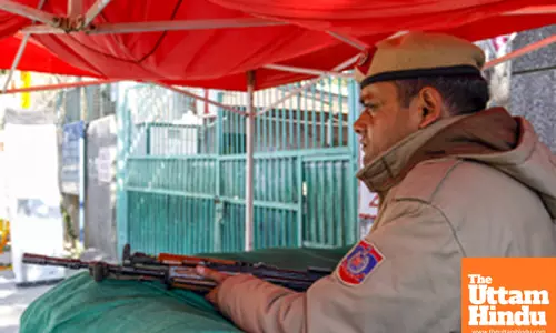 Delhi Police personnel conduct security preparations at the Gole Market counting center