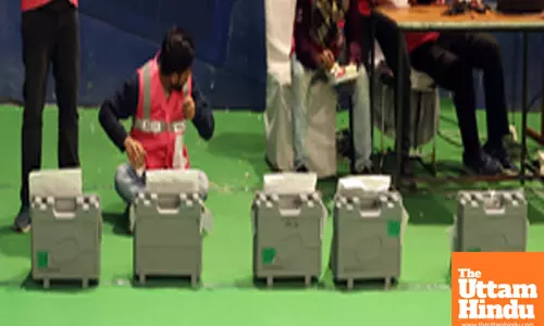 Counting officials tally votes after the Delhi Assembly election
