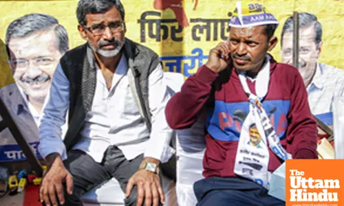 AAP supporters wait outside the Aam Aadmi Party office