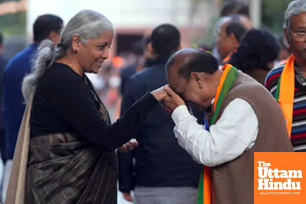 Union Finance Minister Nirmala Sitharaman is greeted by party leader Om Prakash Sharma at BJP headquarters