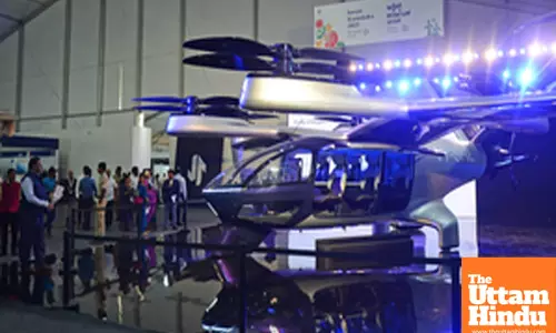 Visitors explore exhibition stalls at Invest Karnataka 2025