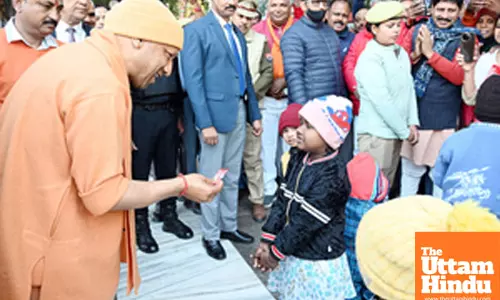 Uttar Pradesh Chief Minister Yogi Adityanath distributes chocolates to children at Shri Gorakhnath Temple premises