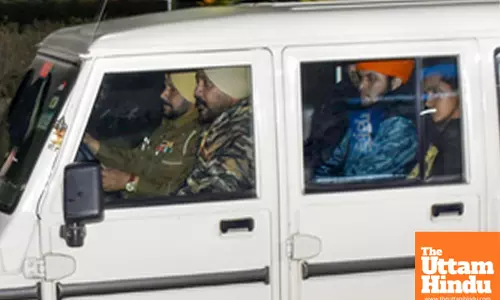 Police escort the Indian immigrants who were deported from US