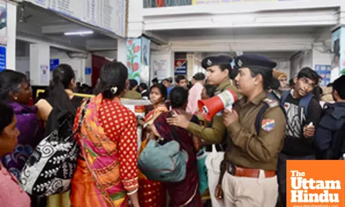 RPF personnel attempt to control a massive crowd at Hatia Railway Station