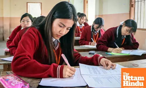 Students diligently write their COHSEM Class XII Examination paper inside the exam hall