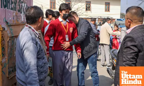Officials conduct thorough checks at the entrance of Tamphasana Girls Higher Secondary School